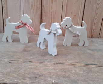 A Trio of Handpainted Wooden Terriers With Ribbon